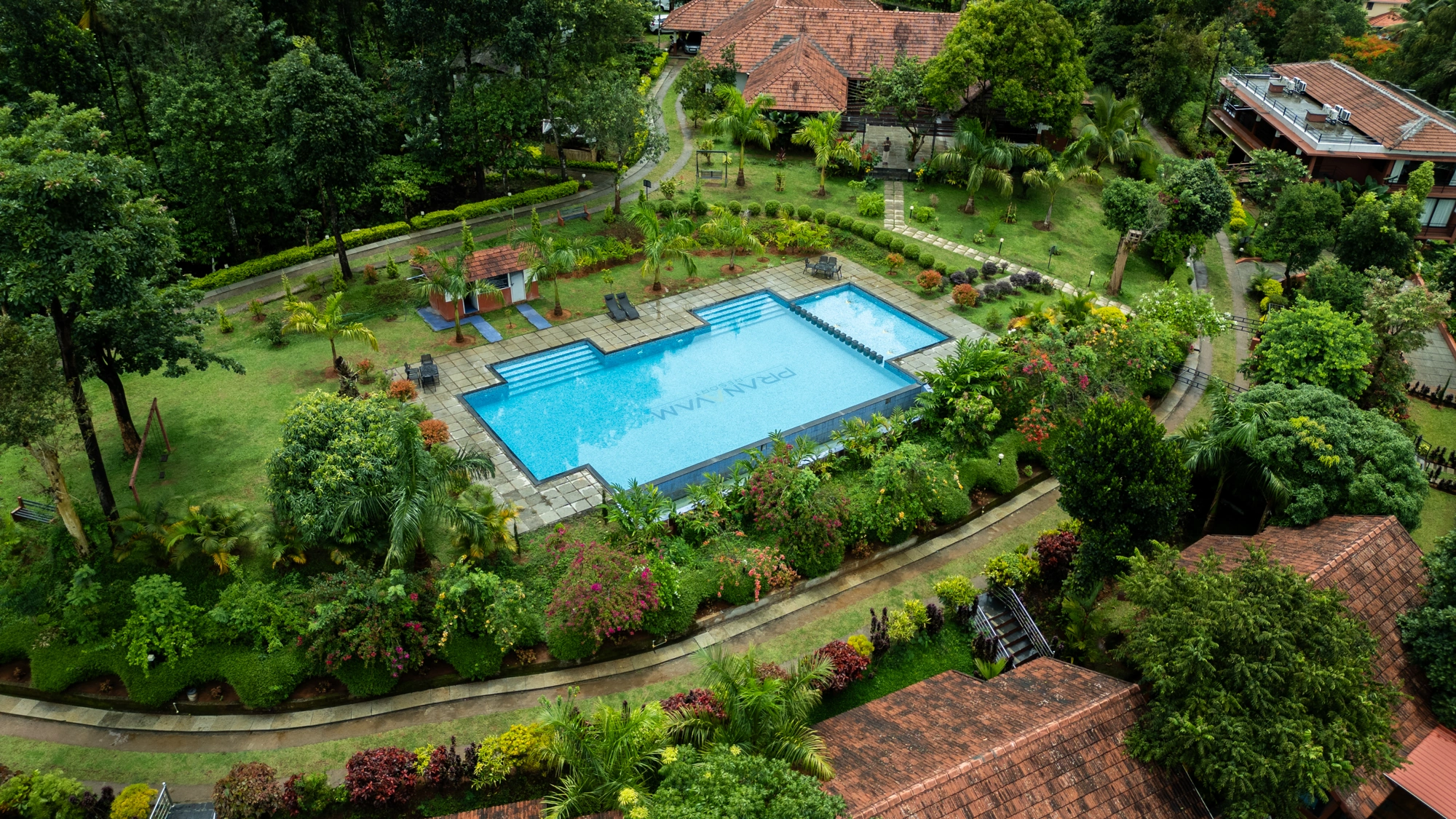 Overhead shot of swimming pool at Pranavam Resort amidst Wayanad hills
